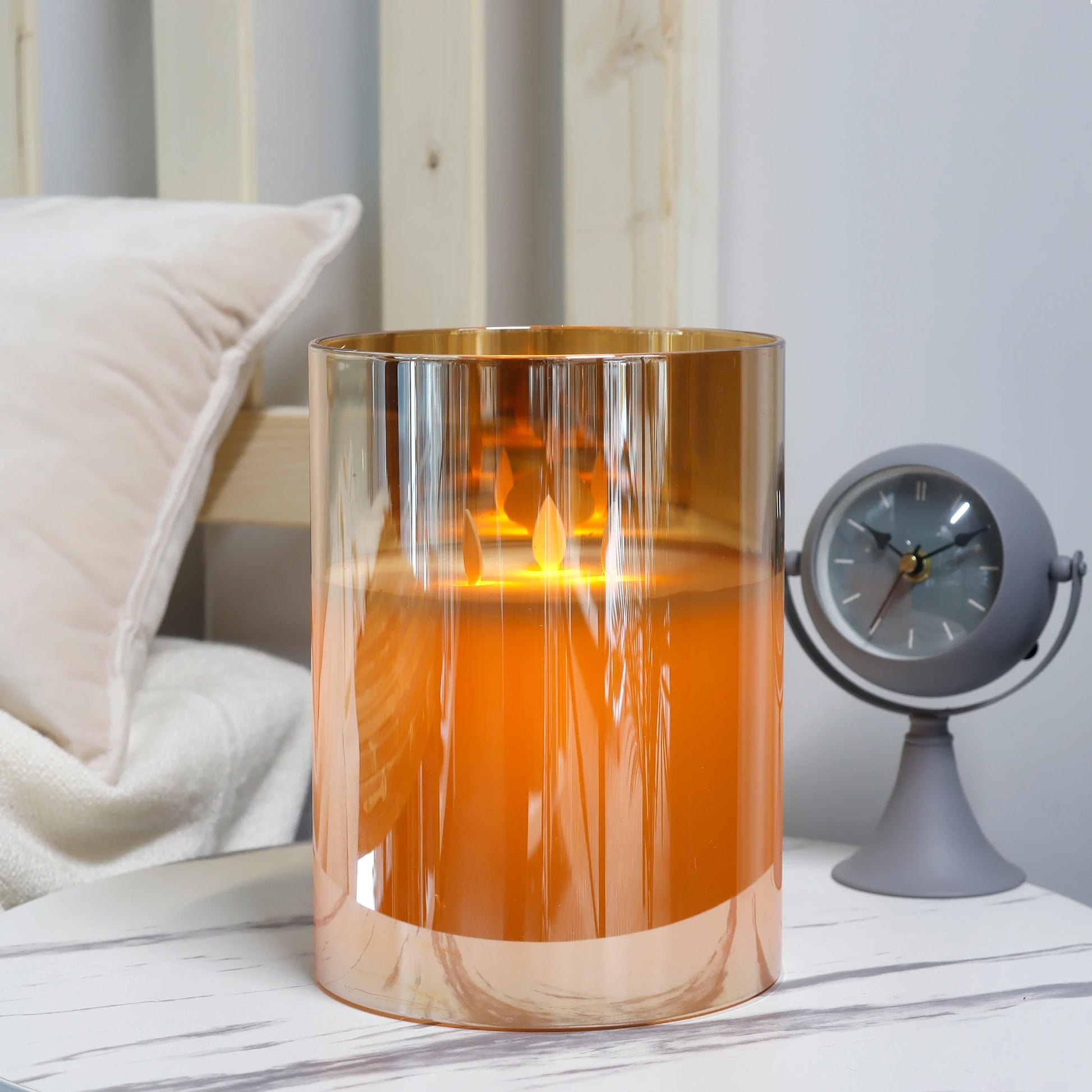 3-wick battery operated LED candle in gold glass on marble surface with clock, elegant bedroom decor